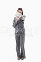 Businesswoman approving and hiding with bank notes in her hand
