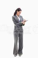 Businesswoman focusing and writing on a clipboard