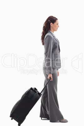 Profile of a businesswoman with a suitcase