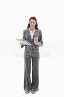 Businesswoman smiling with a coffee and newspaper