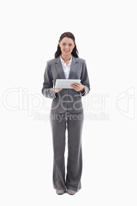 Businesswoman smiling with a touch pad