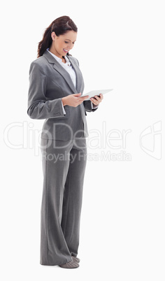 Profile of a businesswoman smiling while watching a touch pad