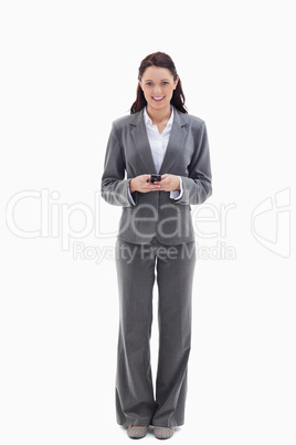 Businesswoman smiling while holding her mobile