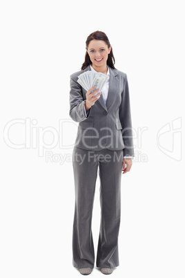 Businesswoman smiling and holding a lot of dollar bank notes