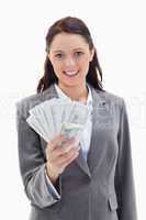 Businesswoman smiling and holding a lot of dollar bank notes