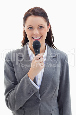 Businesswoman smiling and holding a microphone Businesswoman smiling and holding a microphone