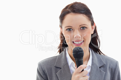 Businesswoman holding a microphone