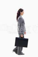 Profile of a businesswoman walking with a briefcase
