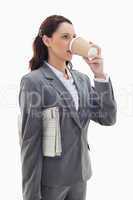Businesswoman with a newspaper drinking a coffee