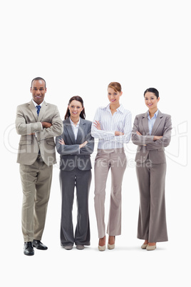 Business team smiling side by side and crossing their arms