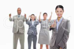 Approving business team with thumbs-up