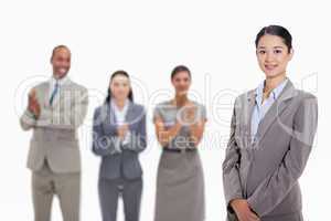Businesswoman with co-workers applauding in the background