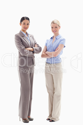 Two smiling women crossing their arms