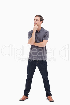 Thoughtful standing man and his legs apart