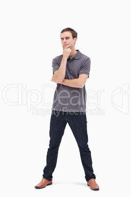 Thoughtful standing man with his legs apart