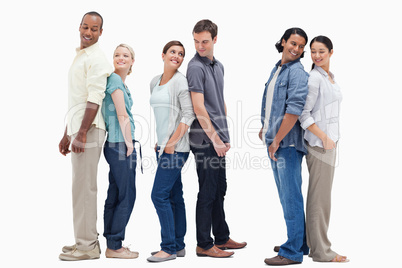 Three couples standing back to back looking at each other