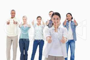 Close-up of people smiling with their thumbs-up