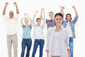 Close-up of a woman with people raising their arms