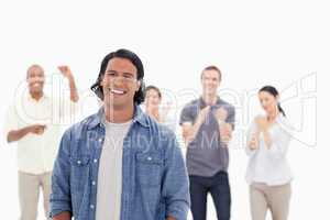 Close-up of a man laughing with people applauding