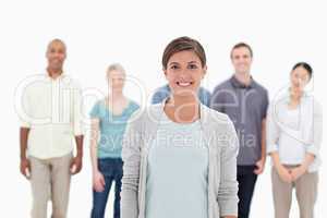 Close-up of a woman smiling with people behind her