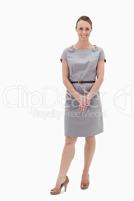 Smiling woman standing up and holding her hands