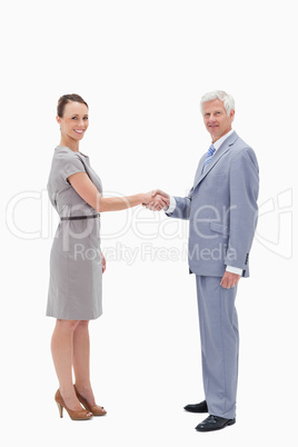 White hair man face to face and shaking hands with a woman