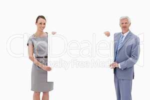White hair businessman holding a big white sign with a woman
