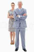 White hair businessman with a woman in background smiling and cr