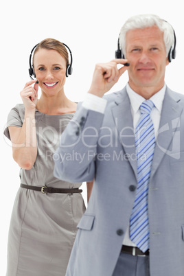 Close-up of a smiling woman in background and wearing a headset