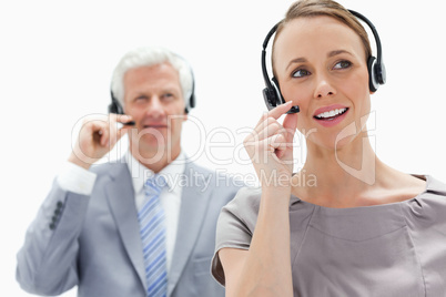 Close-up of a woman talking and wearing a headset with a white h