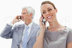Close-up of a smiling woman making a call with a white hair busi