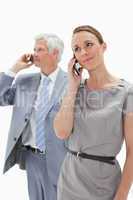 Close-up of a woman making a call with a white hair businessman