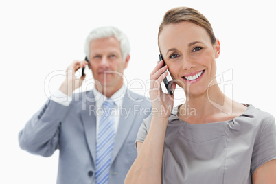 Close-up of a smiling woman making a call with a white hair man