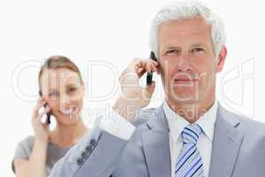 Close-up of a white hair businessman on the phone with a smiling