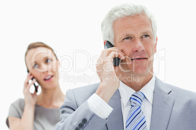 Close-up of a white hair businessman talking on the phone with a