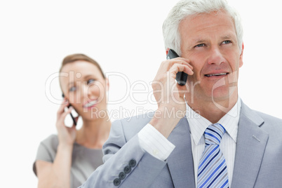 Close-up of a white hair businessman talking on the phone with a