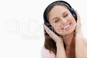 Close-up of a smiling girl listening to music