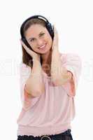 Smiling girl with pink shirt wearing headphones