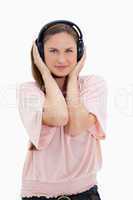 Girl with pink shirt wearing headphones