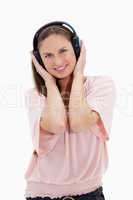 Girl smiling with pink shirt wearing headphones