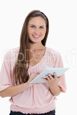 Close-up of a smiling girl using a touchpad