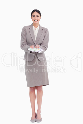 Smiling young businesswoman with bank notes in her hands