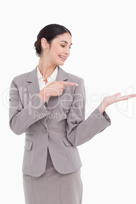 Smiling businesswoman pointing at her palm