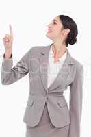 Smiling businesswoman looking and pointing up