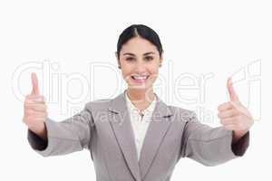 Young businesswoman with a smile giving thumbs up