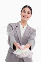 Smiling businesswoman handing over money