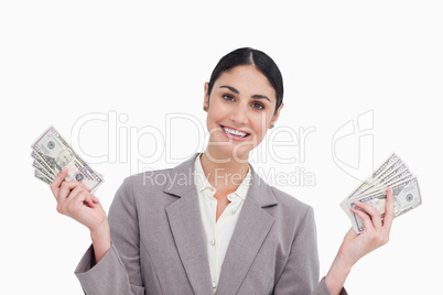 Smiling saleswoman with money in her hands
