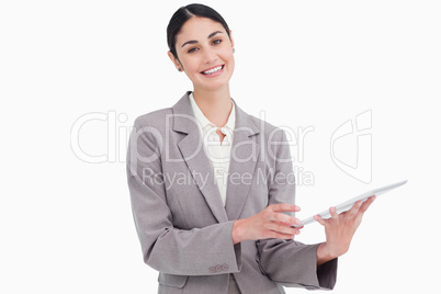 Smiling young saleswoman with her tablet computer