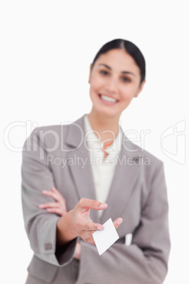 Business card being handed over by smiling saleswoman