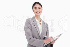 Smiling businesswoman with pen and clipboard